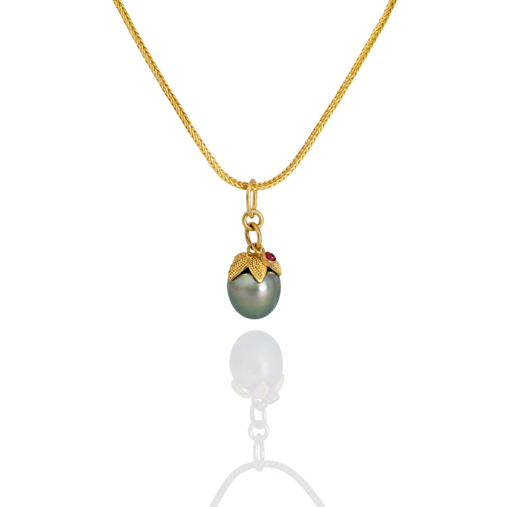 The Acorn Pearl charm on a handwoven chain.