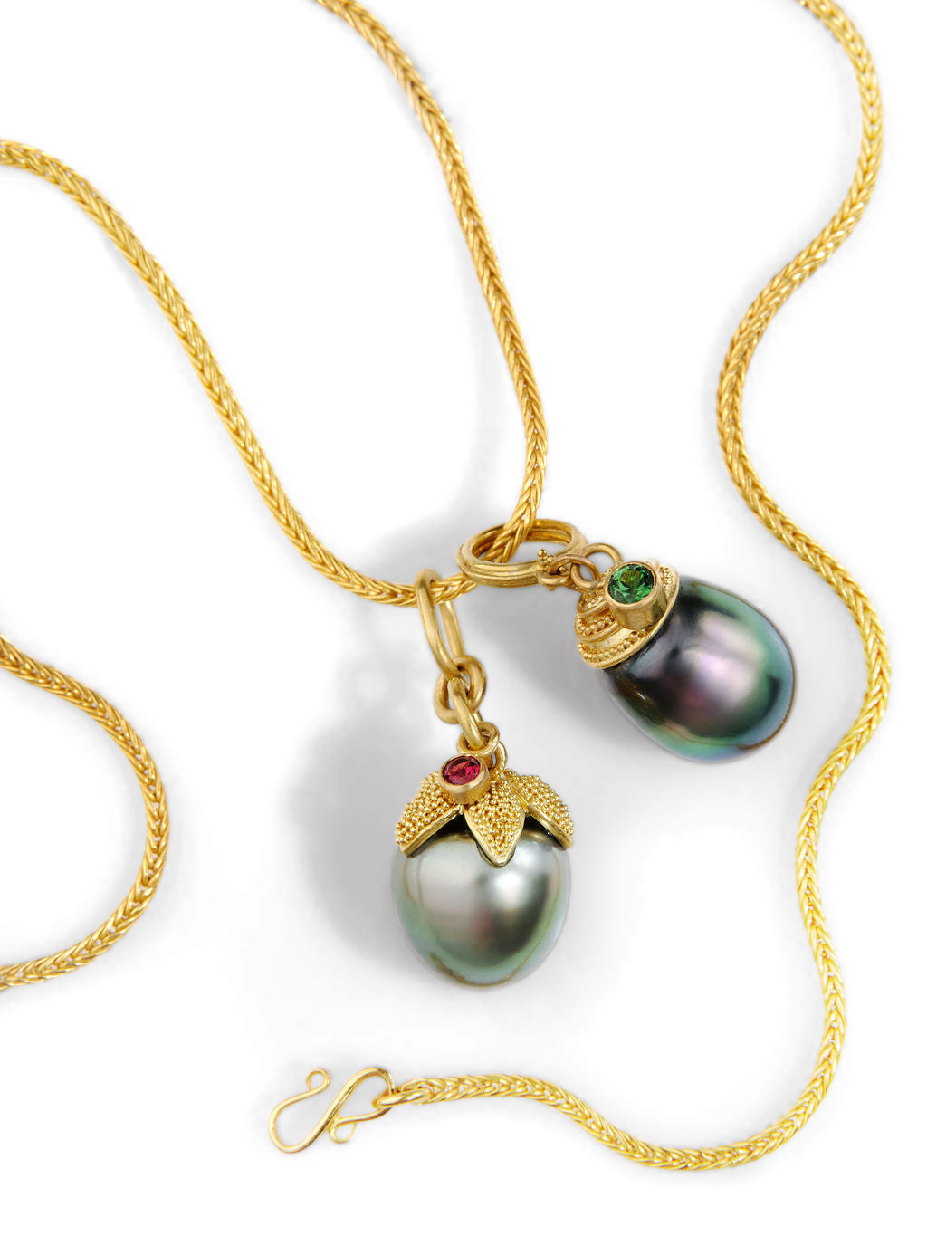 The Acorn Pearl and Spiral Pearl charms on a handwoven chain.