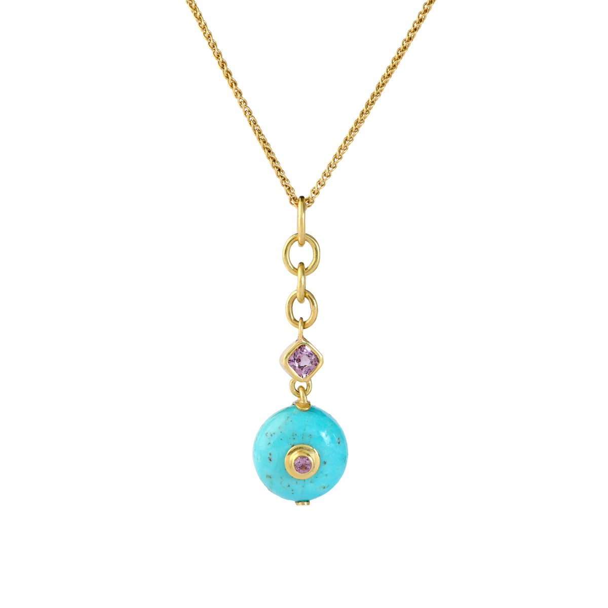 With its classic robins' egg blue color, this beautiful turquoise from Arizona's famed Sleeping Beauty mine makes a timeless and versatile gemstone studded charm. Lavender spinel complement the soft blue, containing a hint of delicate matrix. So, bring out a gold chain or silk or leather cord and wear it with everything. Length approx. 43mm, width 13mm (L 1.7in W .5in). 
Made from recycled 18k gold, a 13mm  turquois rondelle (13ctw) and Burmese spinel (.53ctw) . Chain available separately. One-of-a-kind.