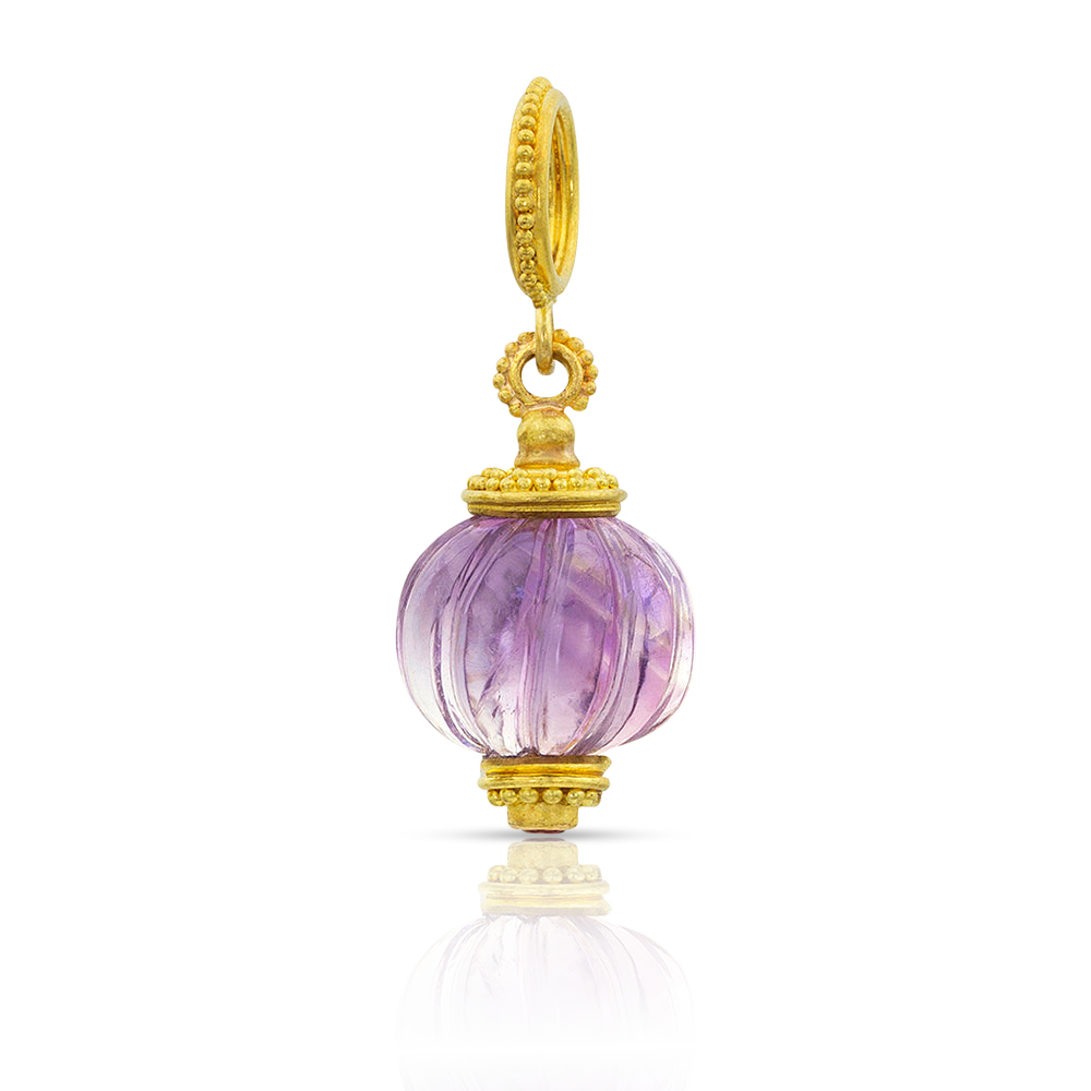 These melon beads are hand carved from selected gemstones and set with delicately granulated caps and bails. The warm buttery tones of the gold gently highlight the melons' "grooves", and at the base of each melon bead, mimicking the blossom end, you will find a tiny, sparkling gem, cradled by granulation that compliments the gemstone it was carved from. Made from 22k yellow gold, 8.1ct amethyst, .05ct Burmese pink spinel.