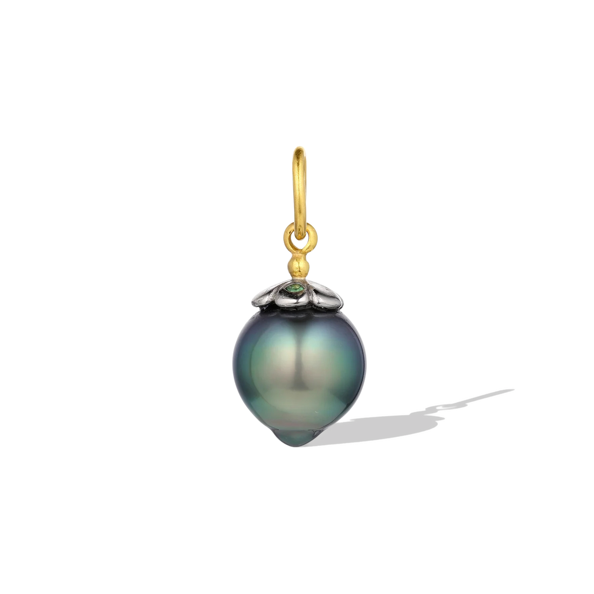 This pearl begged for the coolness of platinum to enhance its color. So a dainty platinum daisy cap sits atop this pear-shaped deep blue green pearl. Grass-green tsavorite garnets alternate on the petals, reflecting the mysterious sea colors. A single, oversize gold granule holds the bail. Length approximately 24mm, width 10.9mm (L .95in W .4in).

Made from recycled 22k gold and platinum, a 10.9x11.9mm cultured Tahitian pearl and Kenyan garnets (.05ct). The chain is available separately.

One-of-a-kind.