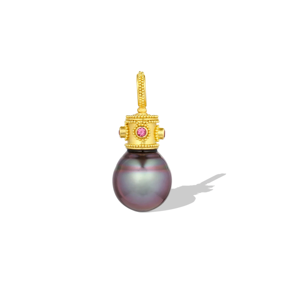 The color in this Tahitian pearl has to be seen to be believed. The intensity of the blue tones overlayed with purple are rare. A bejeweled, golden granulated crown with alternating Jedi and hot pink spinel sits jauntily atop the blue purple drop shaped pearl. The granulated bail accommodates a range of chain sizes. One-of-a-kind. L 29.4mm W 12.6mm (L 1.2in W .5in). Made from recycled 22k and 20k gold, Burmese Jedi spinel (.08ct) &amp; pink spinel (.08ct) and a cultured 12.5x14.8mm Tahitian pearl.