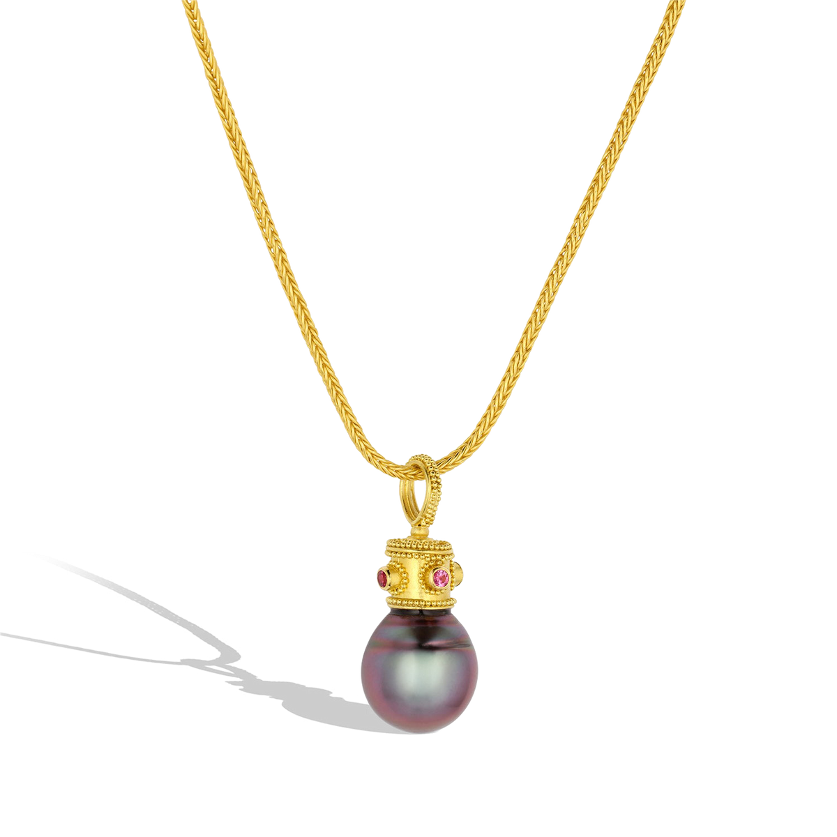 The Purple Byzantine Crown pearl charm shown on a handmade gold chain.