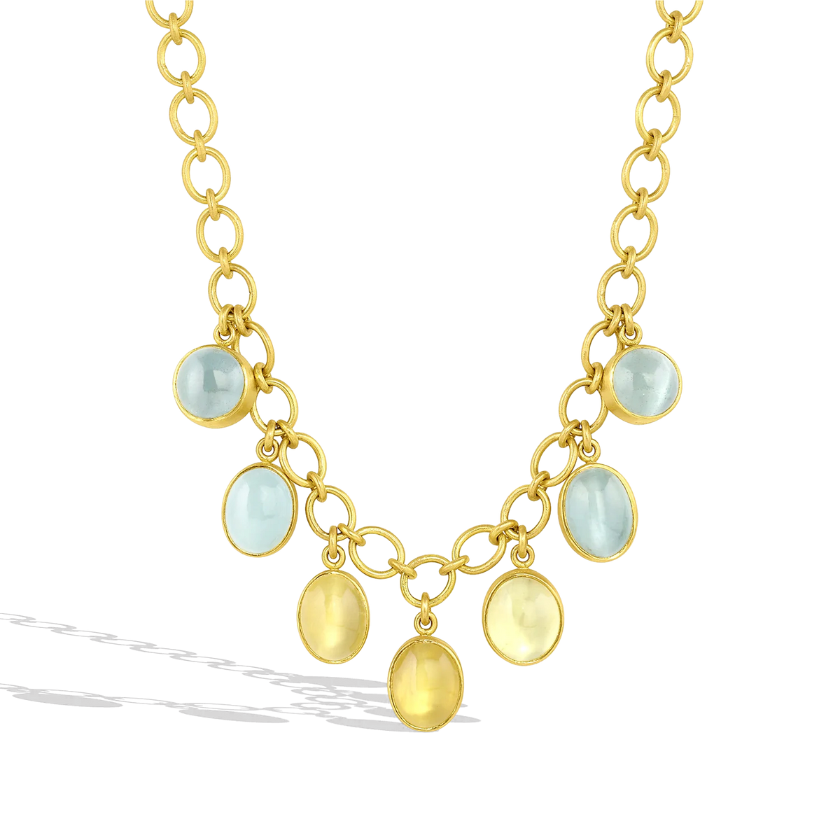 Dainty soft pastel cabochon cut Cat's Eye beryl, aquamarine and heliodor (39.7cts), adorn this 22k gold chain necklace, featuring individually hand shaped links woven together for a classic cable link chain. The chain fastens with our signature Shepherd's Hook clasp, decorated with a golden globe charm set with sparkling Cambodian blue zircons (.31ct). Length 16 inches.

Made with recycled 22k yellow gold and responsibly sourced gemstones.
