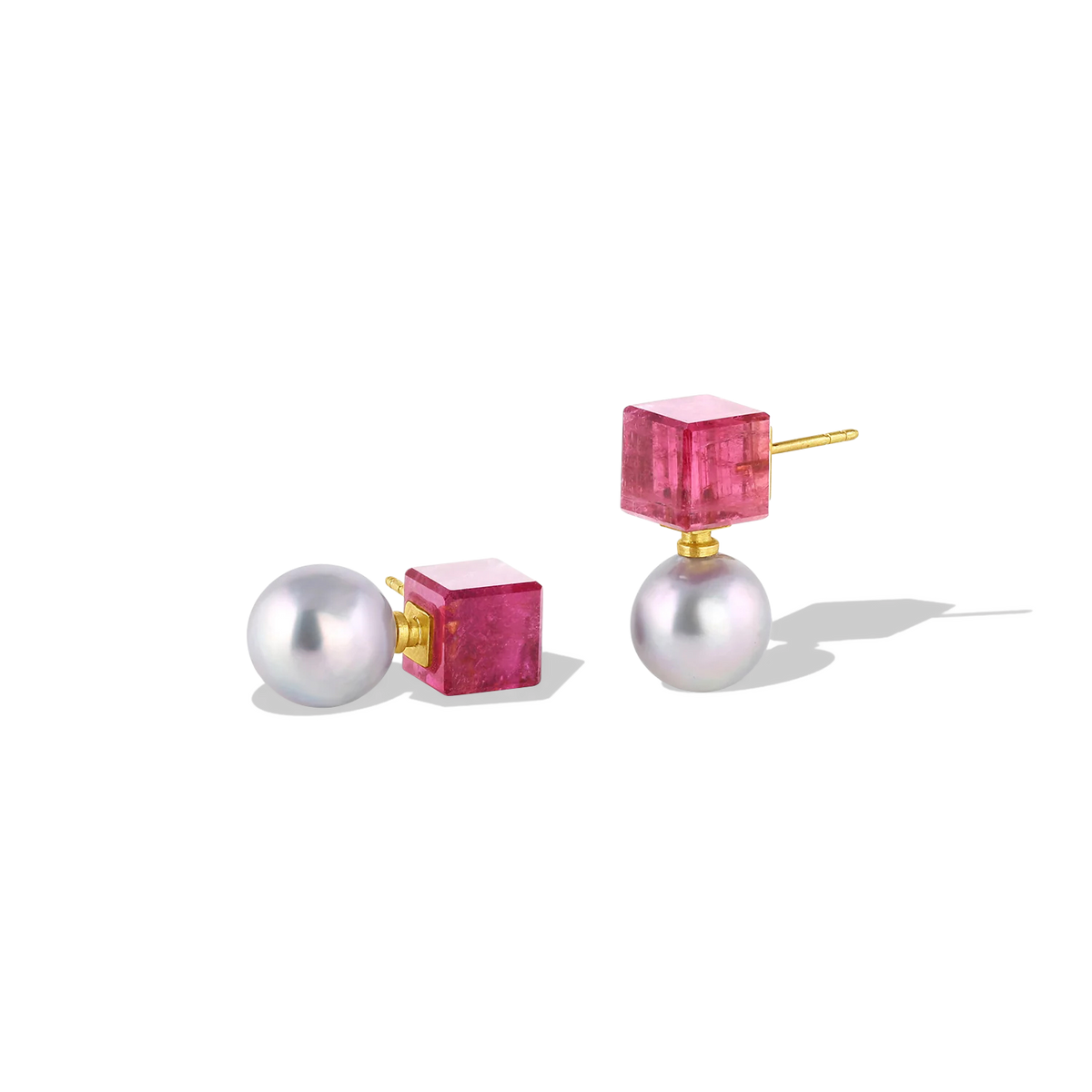 Deep pink tourmaline custom cut cubes provide a striking complement to the metallic blue tones of the Akoya pearls in these earrings. These unique stud earrings bridge the geometric modern and antiquity, with pearls being prized since ancient times. The buttery warmth of high karat yellow gold provides a rich patina. Length approximately 22mm W 10.5mm (L .8in W .4in).

Made in recycled 22k yellow gold, rubellite tourmaline (15.4ct) and 10.5mm Japanese blue Akoya pearls.

One-of-a-kind.