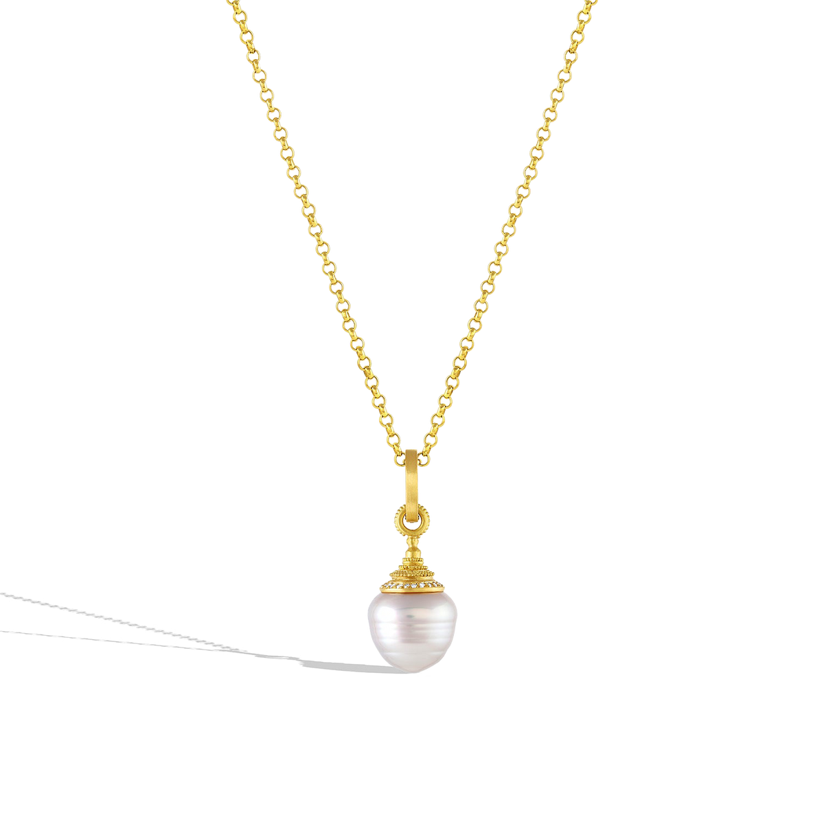 The medium Diamond Acorn pearl charm shown on a gold chain. 