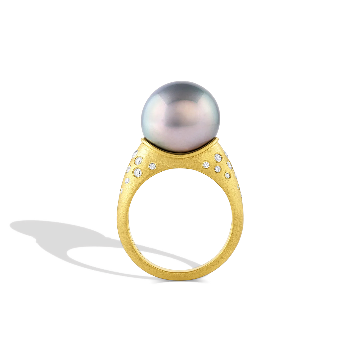 A luminous soft silver blue toned perfectly round pearl is surrounded by sparkling graduated diamonds scattered along the curves surrounding the pearl. A parchment like texture gives a soft papery feel to the fingertips and a satiny look to the gold.

Made in recycled 22k yellow gold, Canadian diamonds (.30ct) and a cultured Tahitian pearl. Size 7. Can be resized. One of a kind. This ring can be made with other pearl options, please contact concierge@atelierwolff.com to discuss.