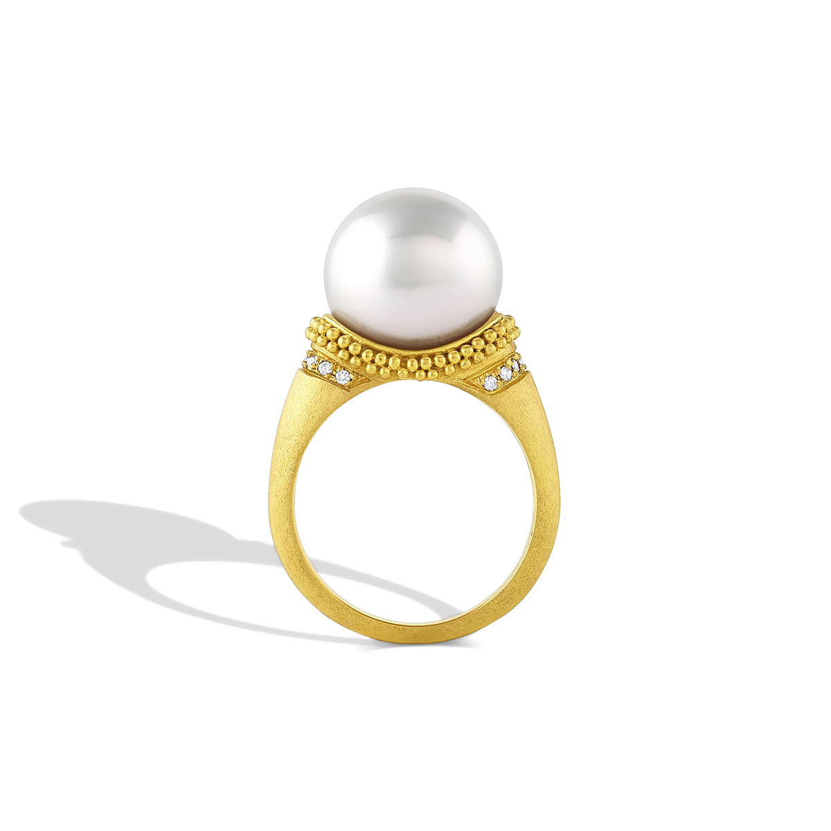 The folds and drape in the fabric and lace in Elizabethan ruffs were the inspiration behind this ring. Soft, brushed granulation, reminiscent of a velvet-like ruff highlighted with  a half ruff of diamonds, is draped around a glossy, luminous button shaped South Sea pearl. Made in recycled 22k gold and a cultured Paspaley south sea pearl. Size 7.

This ring can be made with different pearl and granulation options. Please contact concierge@atelierwolff.com for more information.