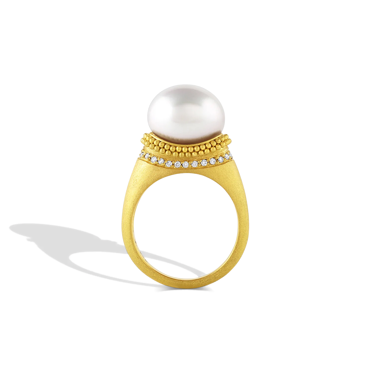 The folds and drape in the fabric and lace in Elizabethan ruffs were the inspiration behind this ring. Soft, brushed granulation, reminiscent of a velvet-like ruff highlighted with a full ruff of diamonds, is draped around a glossy, luminous button shaped South Sea pearl. Made in recycled 22k gold and a cultured Paspaley south sea pearl. Size 7.

This ring can be made with different pearl and granulation options. Please contact concierge@atelierwolff.com for more information.