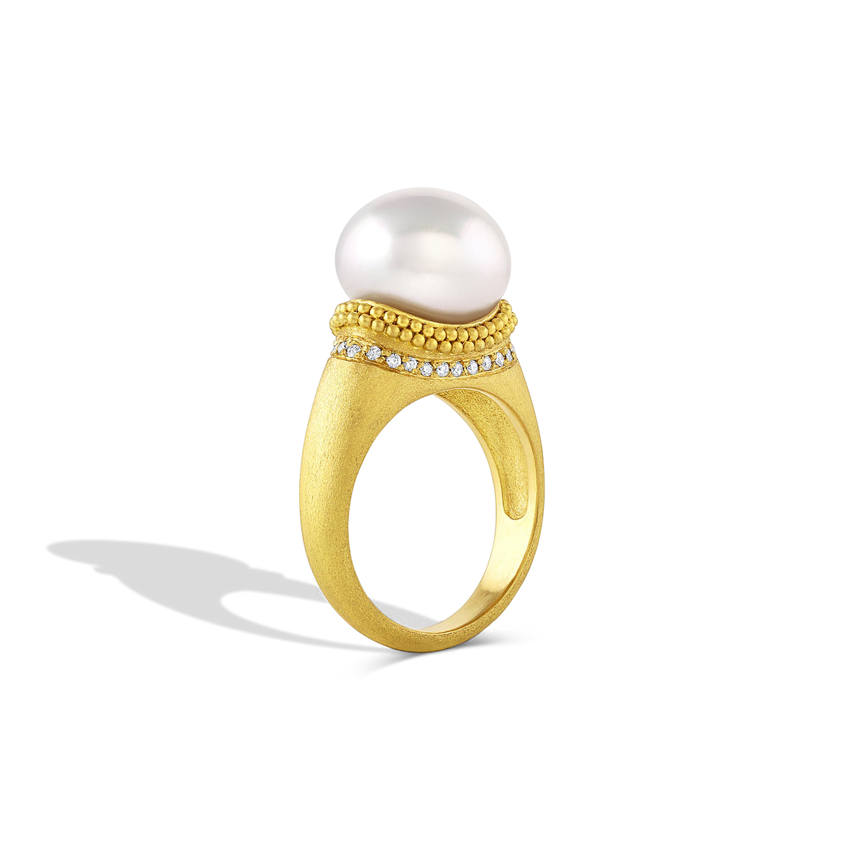 Side view of the Velvet Ruff ring with a full ruff of pave diamonds underneath the granulated ruff.