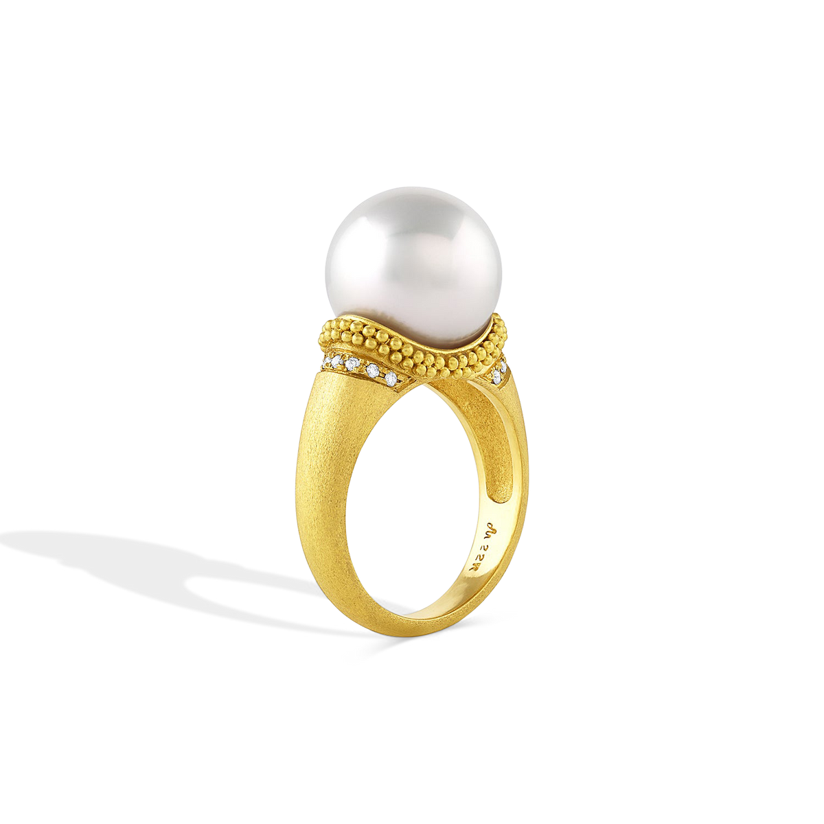 Side angle view of the Velvet Ruff ring with a half ruff of pave diamonds below the granulation.