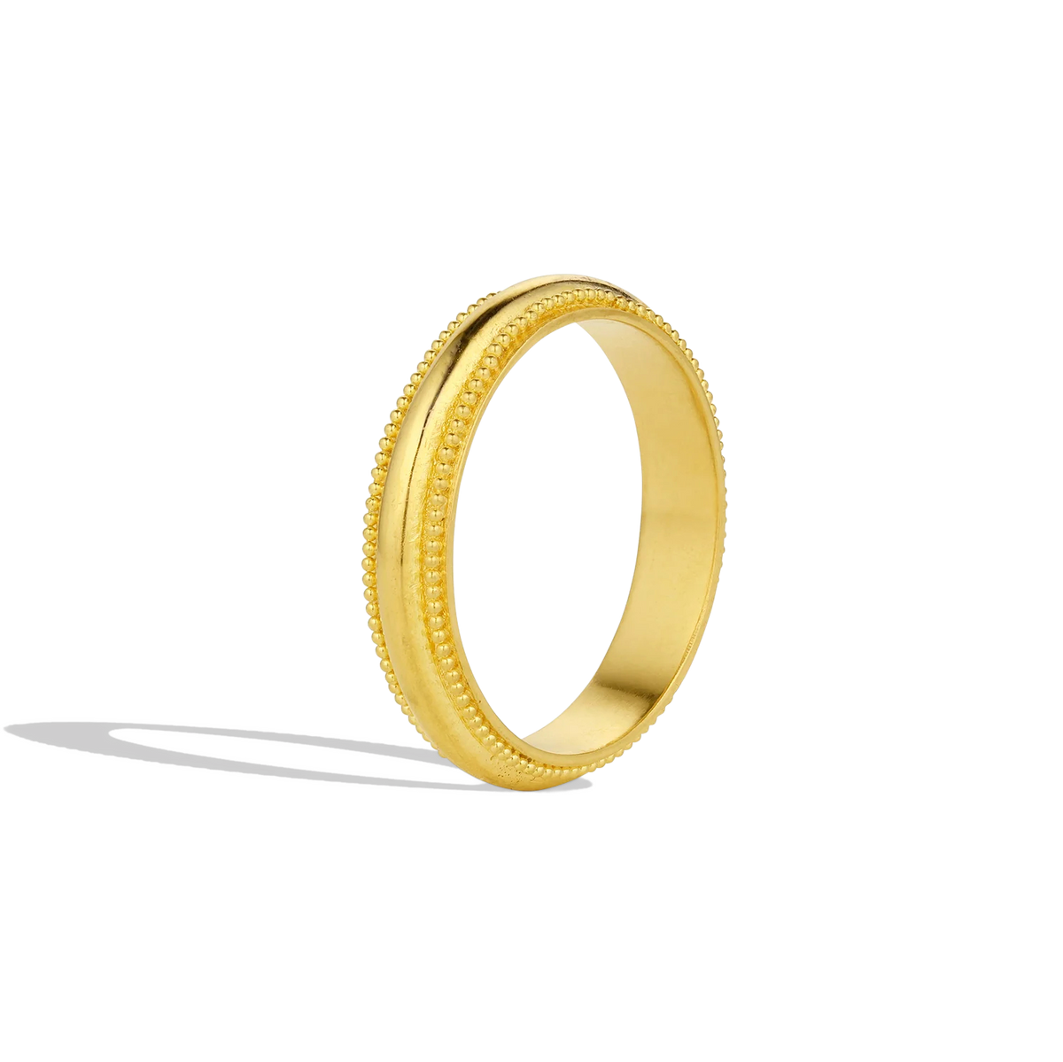 An elegant handmade domed band inspired by the oldest classical Greek order of architecture. Doric is the simplest order, noted for its simplicity, fluted curves and lack of decoration. Here, a line of granulation is placed either side of the domed silhouette to give additional form and volume - an unexpected decorative feature. Although ancient in style, the effect is clean and modern. Perfect for wearing alone or with your favorite stacking rings. Made in recycled 22k yellow gold. Size 6.5. Made to order.