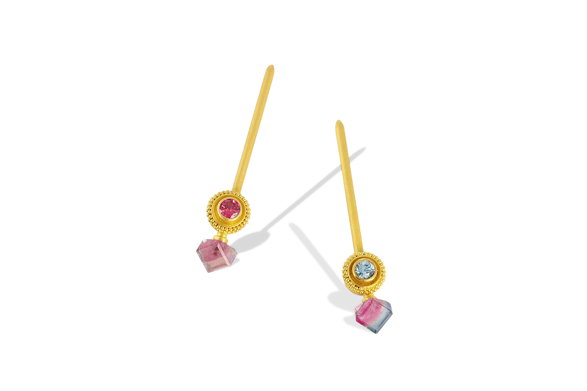 Golden spheres delicately edged with a ruff of granulation set with deep pink spinel and blue zircon are the perfect foil for unusual bright pink and blue tourmaline cubes. Long, elegant brushed golden sticks allow the spheres and cubes to swing gently from the ear, giving a "barely there" feeling. These are a one-of-a-kind piece - no combinations of gemstones are repeated. L 46.8mm W 9.2mm.

Made in recycled 22k yellow gold, Brazilian tourmaline (4.69ctw), blue zircon (.41ctw) and pink spinel (.32ctw).