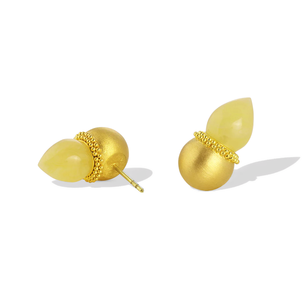 Golden spheres are edged with a ruff of gold granulation and set with polished yellow amber flame pointed drops. As the spheres are hollow, they are light and comfortable to wear. These uniquely shaped and versatile earrings can be worn as ear climbers or as a stud, simply turn the amber point downwards. Length approximately 19.9mm W 11.1mm (L .8in W .4in).

Made in recycled 22k yellow gold and hand carved Baltic yellow amber (4.48ctw).