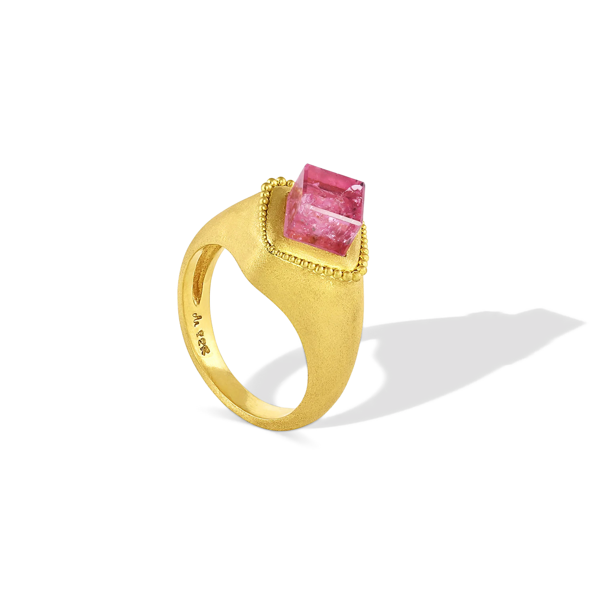 An unusual jujube pink tourmaline cube absolutely cried out to become a signet ring, and so it did! A halo of graduated brushed gold granulation floats around the edges. This ring is for everyone. Unisex.

Made in recycled 22k yellow gold and a Brazilian tourmaline (3.13ct).Size 7. Can be resized. One-of-a-kind.