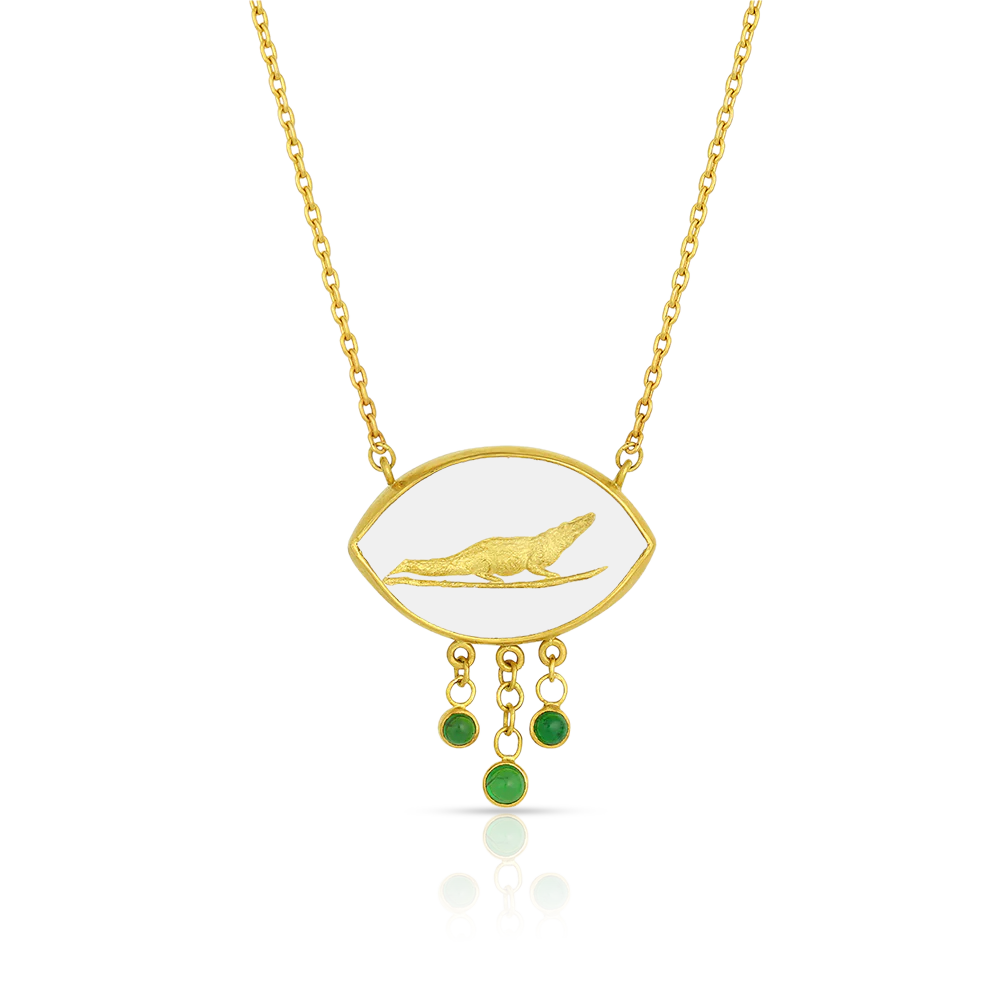 Lovely hand carved and gilded rock crystal pendant depicting a crocodile resting in lotus plants, highlighted with tsavorite garnets. The crocodile was inspired by its namesake found on one of the four faces of the Signet Ring of Horemheb, the last Pharaoh of Egypt's 18th Dynasty. Handmade in recycled 22k yellow gold and Ataléia rock crystal from Brazil, Kenyan tsavorite garnets (.30ctw), the chain is approximately 40.5 cm or 16 in long.

One-of-a-kind.
