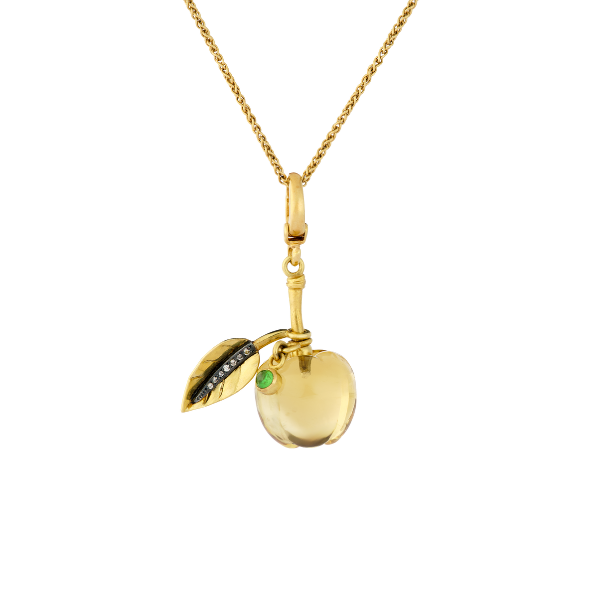 Idunn, the goddess of eternal youth, is the keeper of an eski full of mystical golden apples that preserve the gods of Asgard.  This hand carved golden citrine apple has a moveable diamond veined leaf and green tsavorite garnet, further symbolizing growth, rejuvenation and vitality. Length approx. 38mm, width 24.5mm (L 1.5in W .9in).