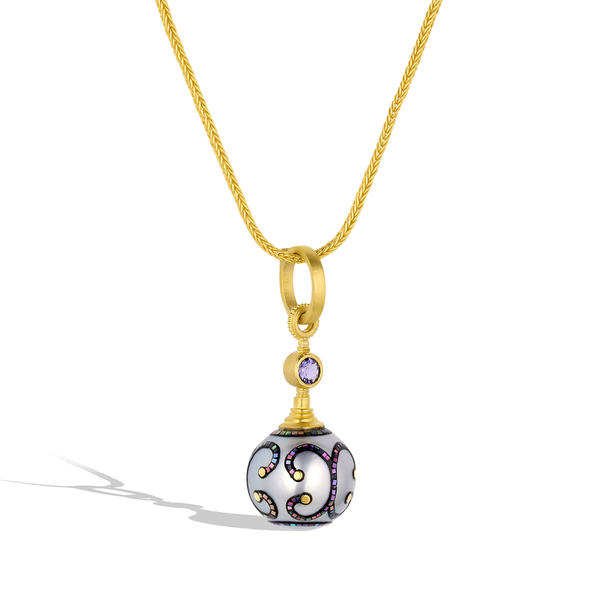 Maki-e pearl charm shown on a handwoven gold chain.