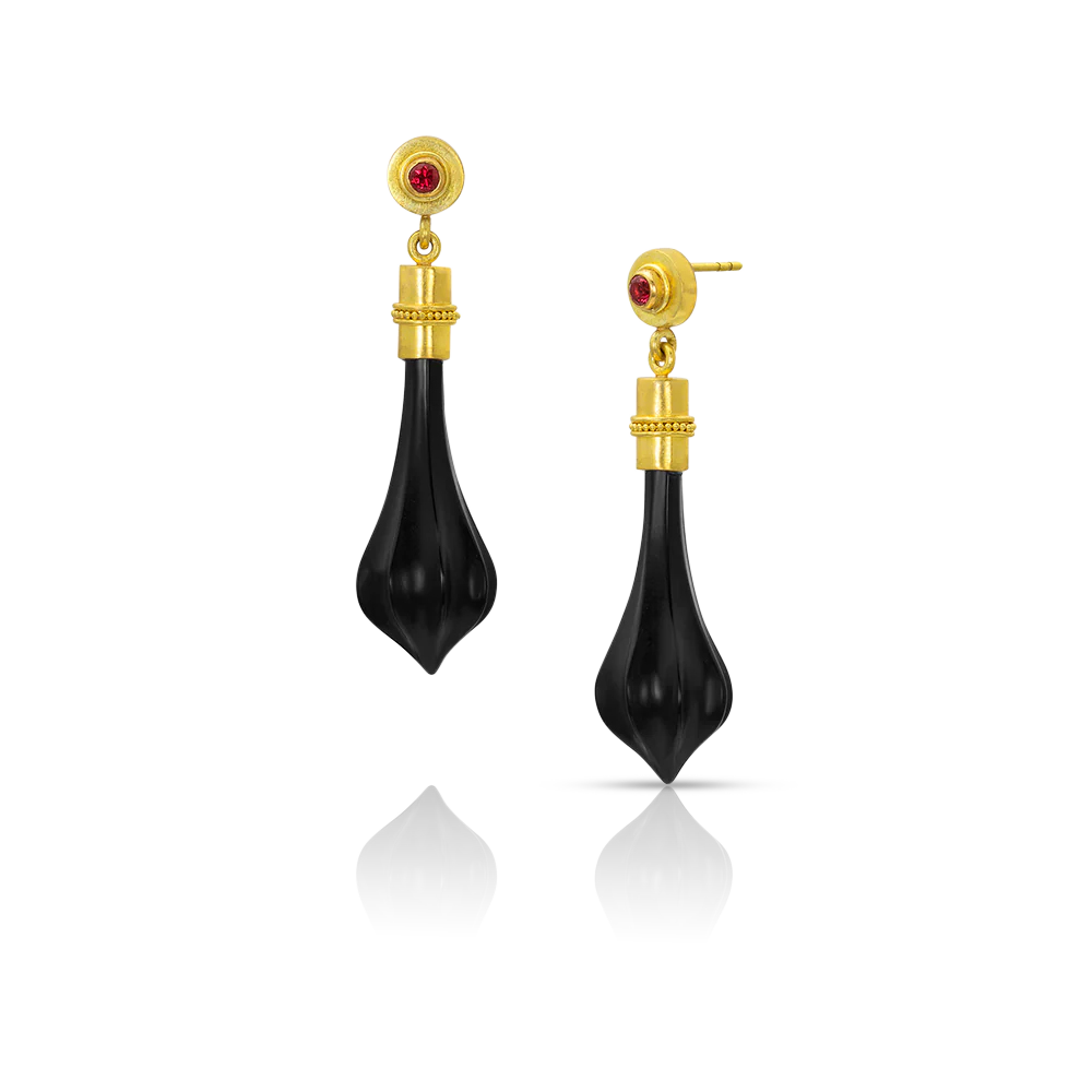 Delicate hand carved matte black onyx "club" shaped drops are a feature of these dainty earrings. Capped with warm gold and velvety granulation, they swing gently from bezel set intensely red spinel. Post and Guardian back.

Made from recycled 22k gold, hand carved onyx and Burmese spinel (.14ctw). Length 41mm or 1.61in.