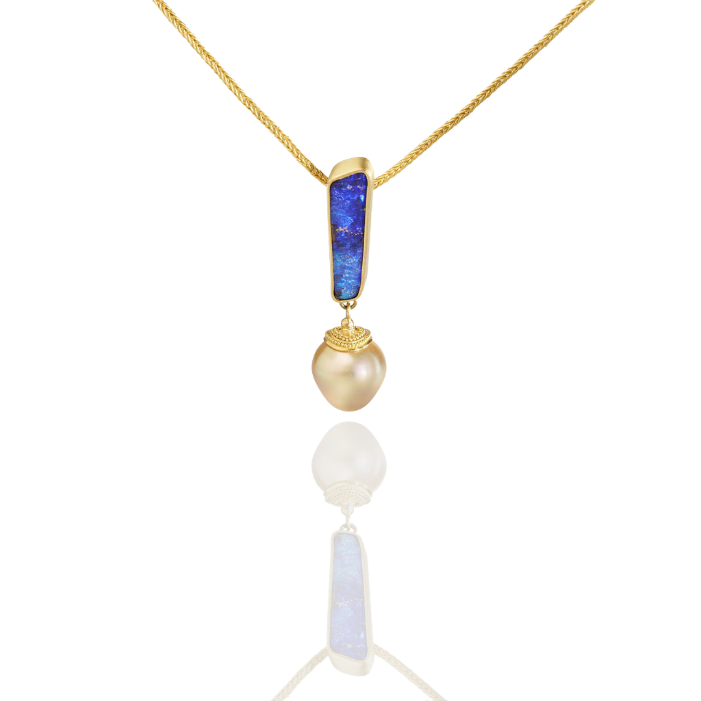 The Opal Exclamation Charm on a chain.