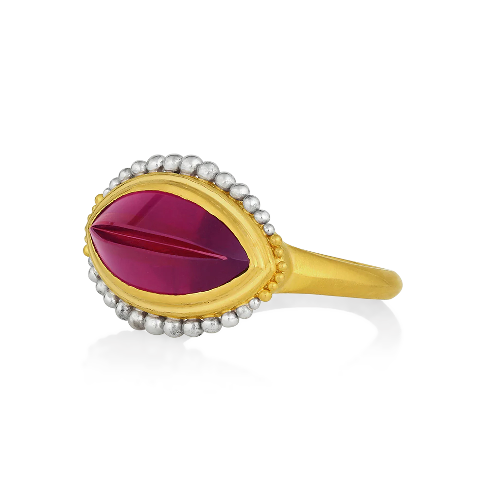 I love carved gemstones and few equal the genius of Tom Munsteiner, master gem cutter. Tom treats each gem as a treasure, creating miniature sculptures of color and light. This rhodolite garnet has an anticlastic curve to it, giving it a beautiful profile and some challenges to make! It is however a truly one-of-a-kind ring with our signature graduated granulation floating around the garnet (4.24ct).

Made in recycled 22k yellow gold and platinum and a Munsteiner garnet. Size 7.