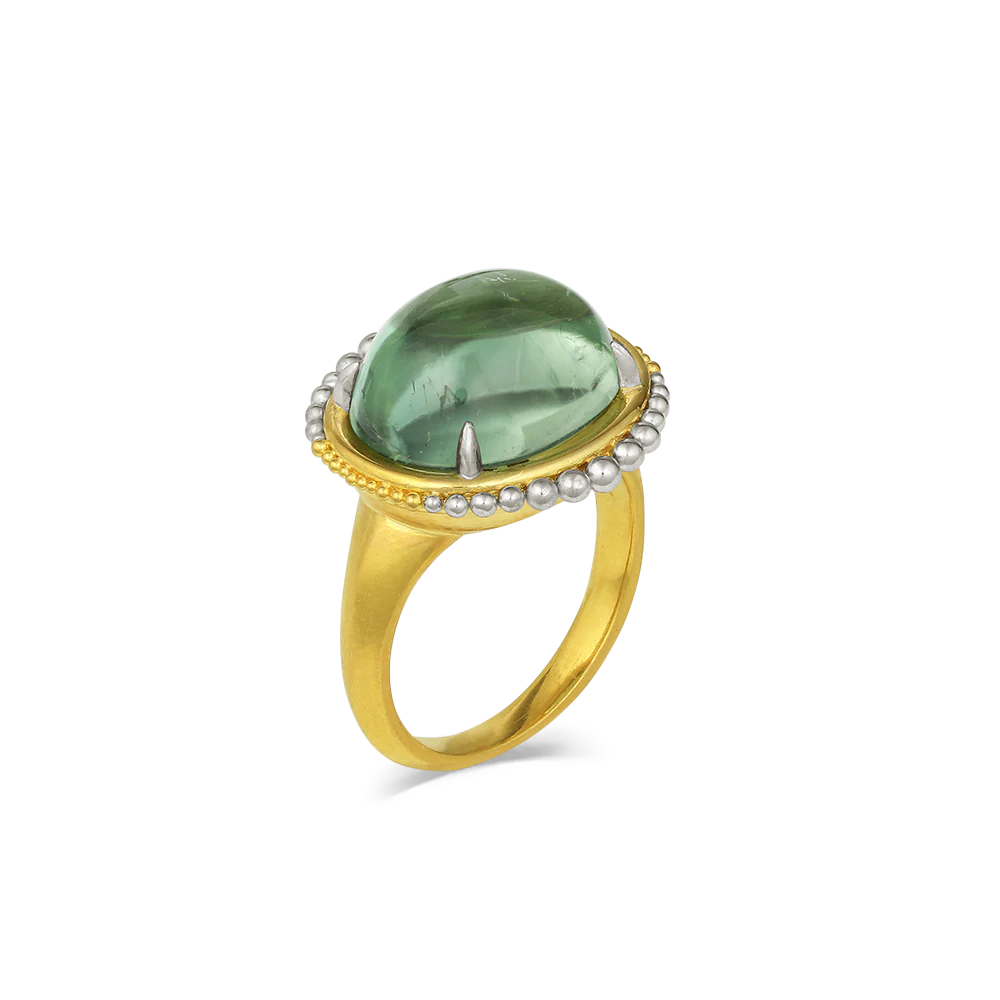 If green is your color, then this is your ring! This glorious sea green tourmaline (11.03ct) has depth and character and makes a splash on your hand. Our signature soft rich gold and polished silvery platinum graduated granulation gives this ring a timeless quality that makes it perfectly at home with jeans through to occasions. It's beautiful. One-of-a-kind.

Made in recycled 22k yellow gold and platinum and a Mozambiquan tourmaline. Size 7.