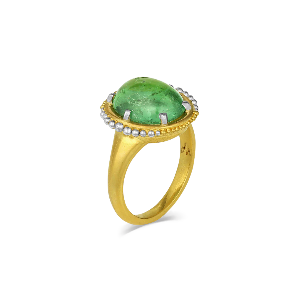The use of platinum along with gold in our signature graduated granulation floating orbit-like around the oval vivid gemmy "gummy bear" green tourmaline (6.23ct), brings a contemporary touch to this ring. If green is your color, this is your ring. It's gemmy, vivid and delicious. Perfect with your favorite fitted tee, crisp button down, cashmere sweater or occasion. One-of-a-kind.

Made in recycled 22k yellow gold and platinum and a Nigerian tourmaline. Size 7.