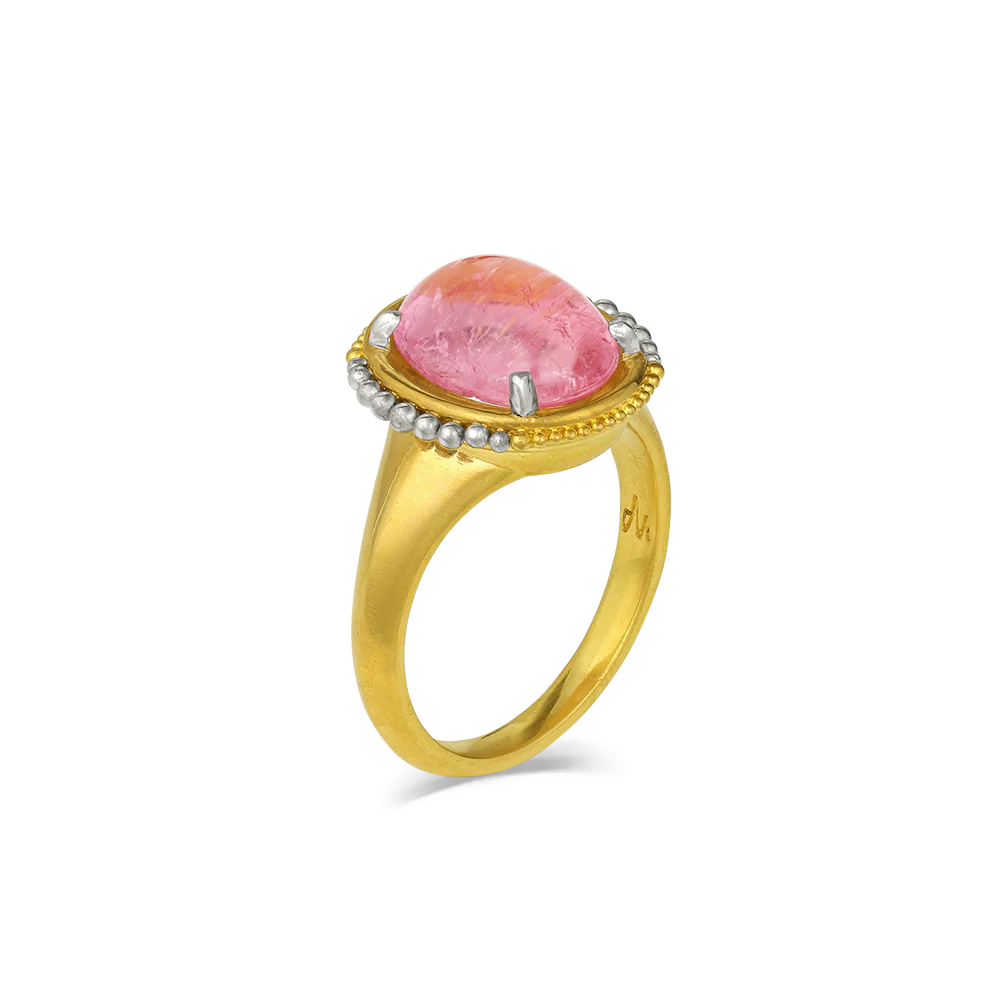 The ancient goldsmiths used granules of different sizes to paint scenes and other decorative finishes on their pieces, working gold or silver, and as far as is known, did not use the metals together. The use of platinum along with gold brings a contemporary feel to the beautiful bubble gum pink tourmaline (4.65ct) in this elegant and striking ring. One-of-a-kind.

Made in recycled 22k yellow gold and platinum and a Nigerian tourmaline. Size 7.