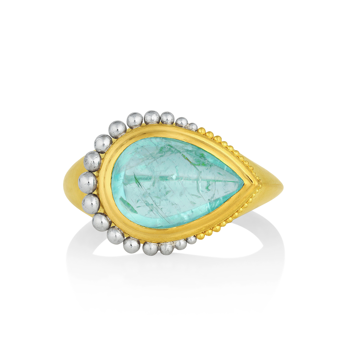 I love unusual gemstones and this one is exceptional. Mozambique produces some truly beautiful gemstones, and this Paraiba tourmaline is such a one. Look closely to see the fine copper needles almost floating in a lagoon blue sea; this stone is for a true gem lover. The shape of the stone meant that it just had to be a signet ring, oversize graduated platinum granulation emphasizes the rounded pear, while the gold granules delineate the elegant point. A statement or a signet ring, either way it is stunning.