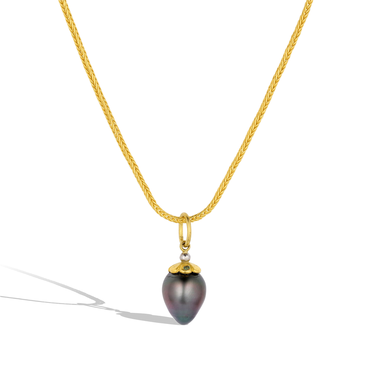 The Peacock Tahitian pearl charm shown on a handwoven gold chain, which is available separately.