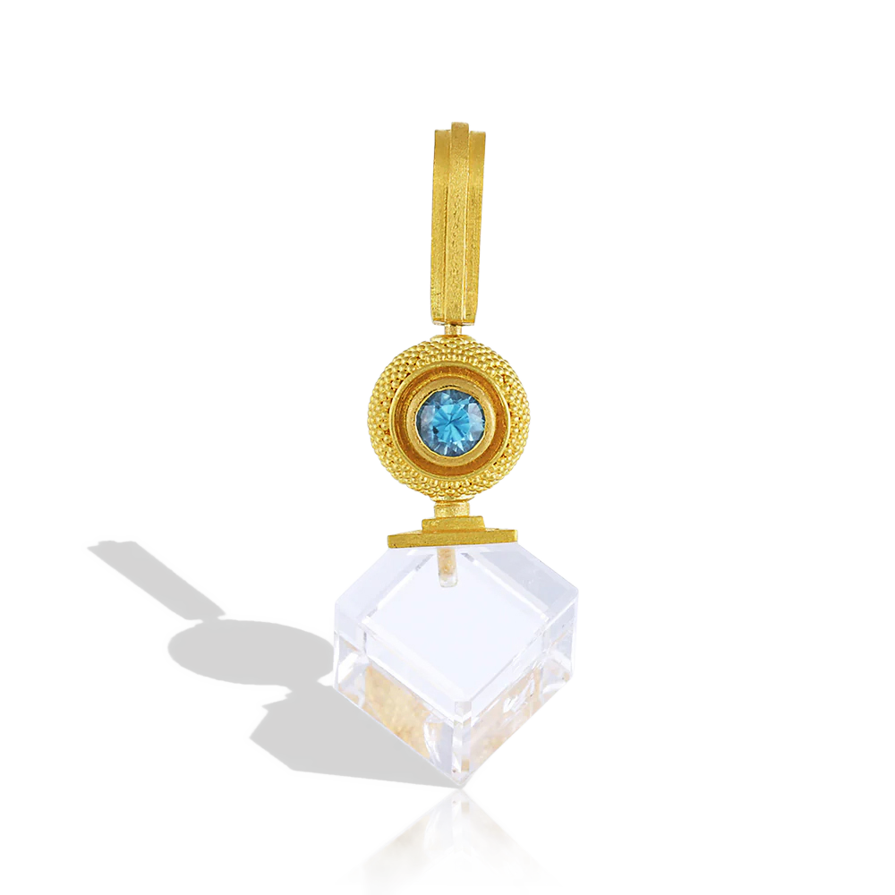 I love movement in jewelry, and this charm swivels around the bail, offering two separate looks, one with the blue zircon and the other with the gold granulated sphere facing outwards.  Rich, buttery high karat gold softens the bold, angular lines of the cube, seamlessly blending the ancient technique of granulation with modern design. Perfect for distinctive, not your usual everyday wear. Length approx. 37.5mm, W 16.5mm (L 1.4in W .6in). Made with recycled 22k yellow gold, Cambodian zircon (.48ctw).