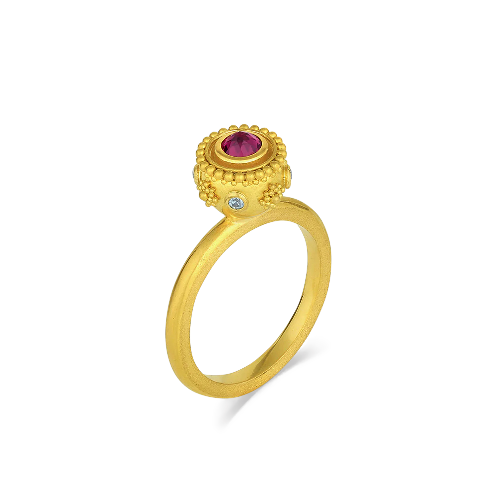 A reverse set mysterious deep purplish red rhodolite garnet (.33ct) centers this charming Sfaira ring with bright blue zircons (.09ct) and a ring of gold granulation orbiting around it around it. Wear as a single ring or create your own story by mixing with your favorite stacking bands or our other Sfaira and Orb rings.

Made in recycled 22k yellow gold, responsibly sourced rhodolite garnet (.33ctw) and blue zircon (.090ctw). Size 7. Can be resized. One-of-a-kind.