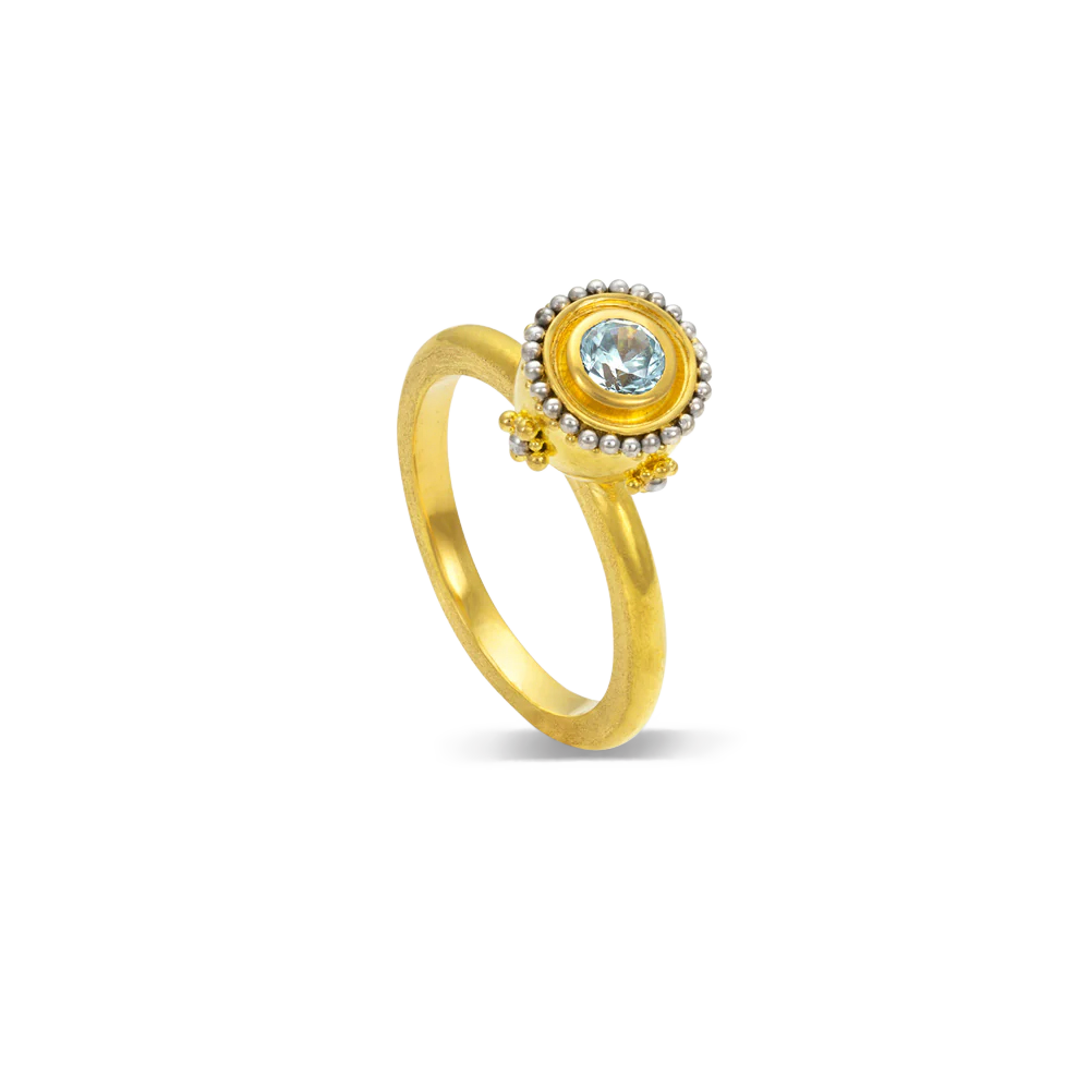 An icy blue zircon with a silvery platinum halo is given an almost medieval feel by the gold and platinum rosettes placed underneath the halo. This bejeweled orb can be worn alone or create your own story by mixing with other Orb rings or your favorite stacking bands.

Made in 22k yellow gold and platinum and a Cambodian zircon (.42ctw). Size 6.5.Can be resized. One-of-a-kind.