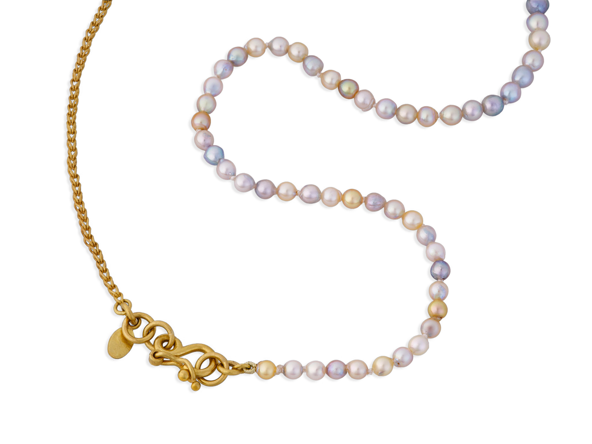 Multi-colored Akoya pearls are combined north-south style with our Athena chain, a handwoven single loop-in-loop style fastened by our signature S clasp.

Length 19 inches. If you would like a different length, please contact us at concierge@atelierwolff.com and we would love to make your strand up for you.

Made with recycled 22k yellow gold and cultured 3-4.5mm Japanese Akoya pearls. Knotted on silk.