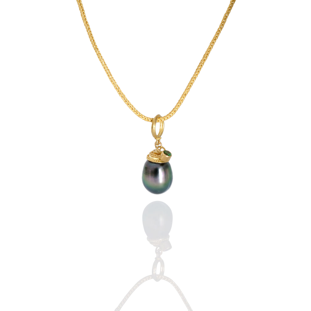 A very special eggplant shaped gray pearl with peacock tones and wonderful luster. A spiral granulated cap takes the eye up and around the pearl to find the sparkling grass green tsavorite garnet floating atop the spiral. Length approx. 27mm, width 10.5mm (L 1.1in W .4in).
 Made from recycled 18k gold & 22k gold, a 13.1x10.5mm cultured Tahitian pearl and tsavorite garnet (.13ctw) from the Scorpion mine in Taita, Kenya. The chain is available separately.