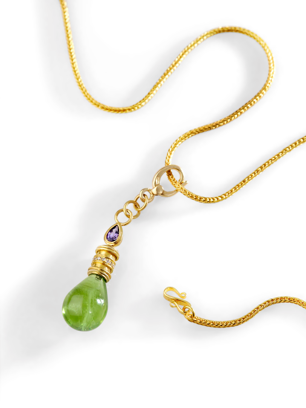 The peridot Perfumer's Flask charm on a chain.