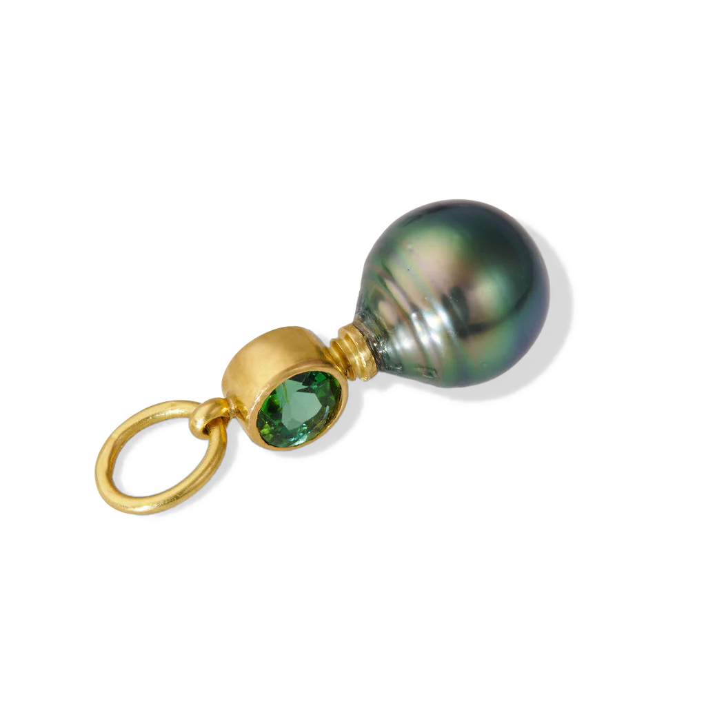 Yes, The Green Charm. A lustrous, vivid, deep green circlé pearl paired with a gorgeous vivid blueish green tourmaline make this a mighty charm. The color and luster of both the pearl and gem are simply stunning! Wear with your favorite chain by itself or mix it up with your favorite charms and chains. Length approx. 27.6mm, width 10.3mm (L 1.1in W .4in). Made from recycled 22k gold, a 10.4x12.5mm cultured Tahitian pearl and Brazilian tourmaline (.71ctw). The chain is available separately.