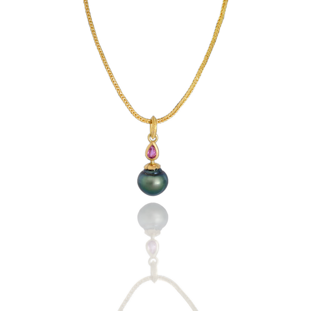 One of our Perfumer's Flask series. A sensuously rounded, flask shaped and beautifully lustrous deep blue circlé pearl has a dainty Arabian Nights style ruby "stopper" atop a flower shaped cap - all in polished 22k yellow gold. A moveable granulated pear-shaped bail completes this one-of-a-kind charm. Length approx. 28mm, width 10.5mm (L 1.1in W .4in). Made from recycled 22k gold, a 10.6x11mm cultured Tahitian pearl and Thai ruby (.19ctw). The chain is available separately.