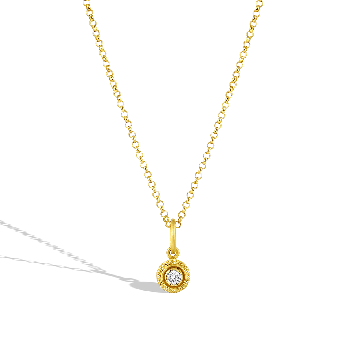 This charm has the silky appearance of a velvet cushion. The gold is smooth and almost soft to the touch, giving an almost hypnotic feel to the fingertips. The buttery tone of the gold is a perfect foil for the diamond sparkle. Although the technique of granulation is ancient, the effect is modern, yet distinct. A charm for everyday wear. The chain is available separately.

Handmade using recycled 22k gold and a reclaimed diamond (VS G .25ct).