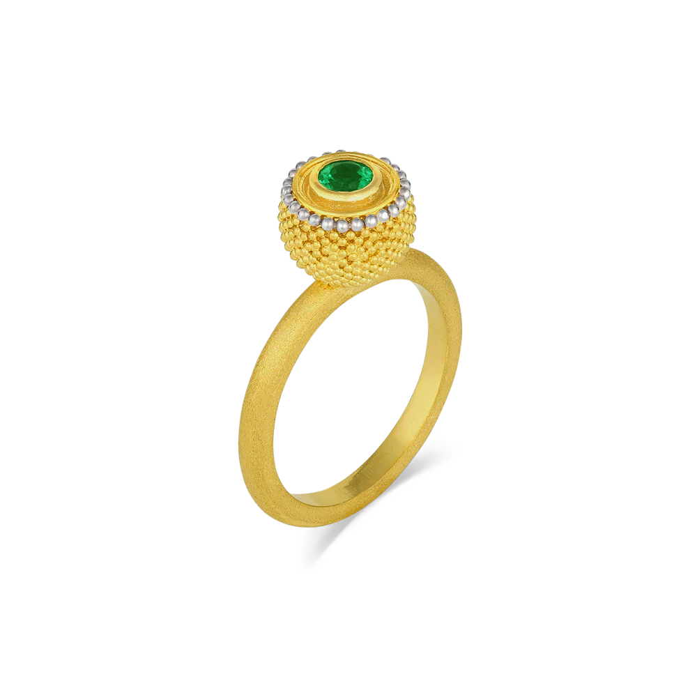 Inspired by the goldsmiths of antiquity, who used gold granules to paint scenes and tableaux on their work, this elegant and versatile ring has the silky appearance of a soft, rounded velvet cushion. The gold is smooth and almost soft to the touch, and a vivid emerald sparkle make it a perfect choice for frequent wear. A parchment like texture gives the ring band a soft parchment like feel.

Made in recycled 22k yellow gold and a Colombian emerald (.27ctw). Size 7. Can be resized.