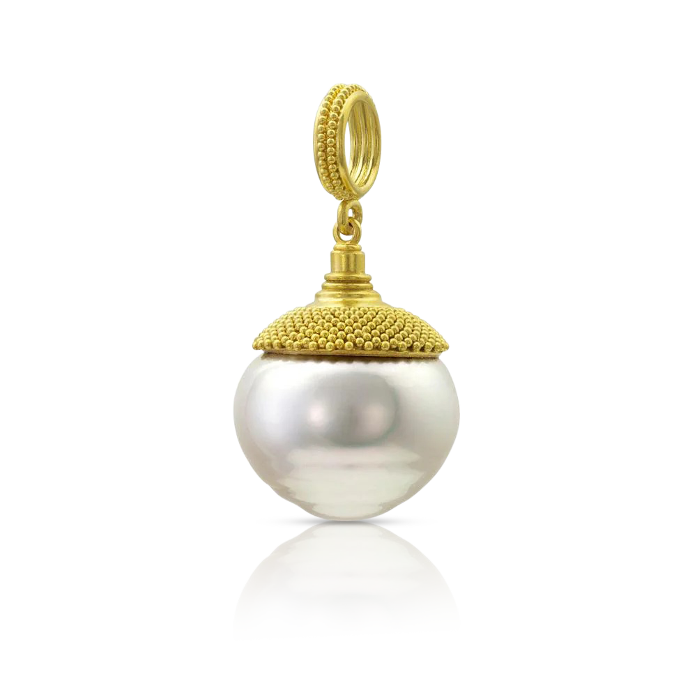 Another of the baroque and circlé South Sea pearls we acquired from Australia. Pearls are one of my favorite "gemstones", and I love saltwater pearls in all their colors and shapes. This is an especially beautiful circlé style, with a sensuous shape. Our signature velvet granulation surrounds a rounded conical cap in a flared pattern reminiscent of a Fibonacci spiral. Length approximately 32mm W 16 (L 1.26 x W .6 in).

Made from recycled 22k gold and a 16mm Paspaley South Sea pearl.

One-of-a-kind.