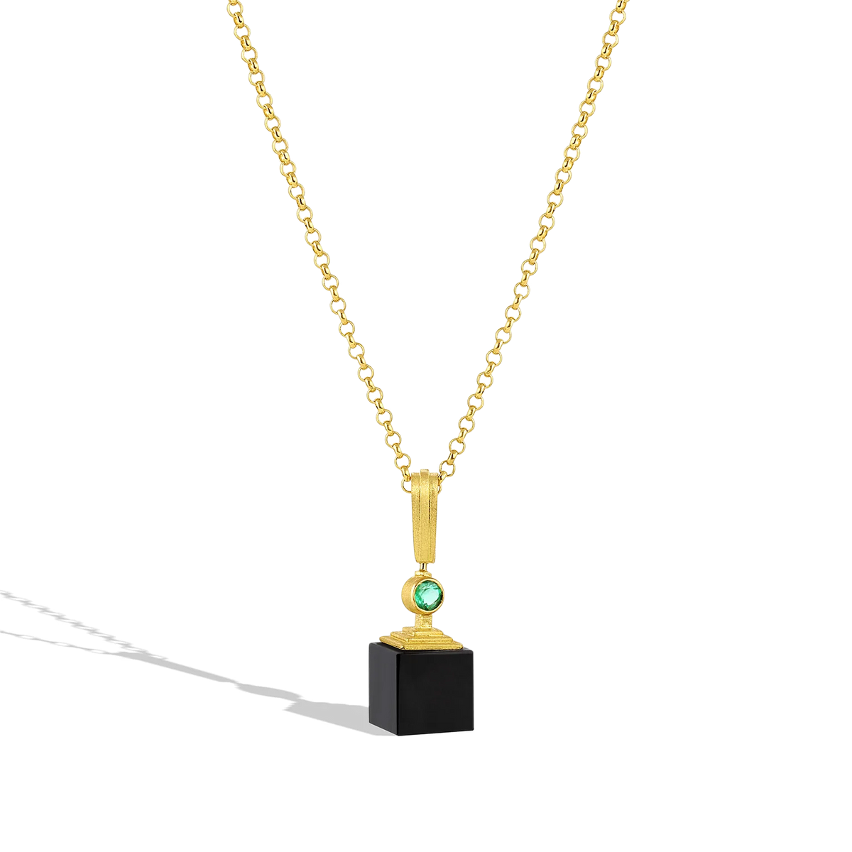 This modern-day ziggurat (or step pyramid) features a custom cut matte black onyx cube topped with a golden step pyramid and emerald. The buttery gold pyramid and emerald seem to float above the onyx, blending the ancient and new.

Custom cut matte onyx (12.77ct) cube topped with a golden ziggurat and Zambian emerald (.25ct). Length approximately 41.5mm W 10mm (L 1.6in W .4in).

Made with recycled 22k yellow gold, Zambian emerald (.25ctw) and black onyx (12.77ctw). Made to order.