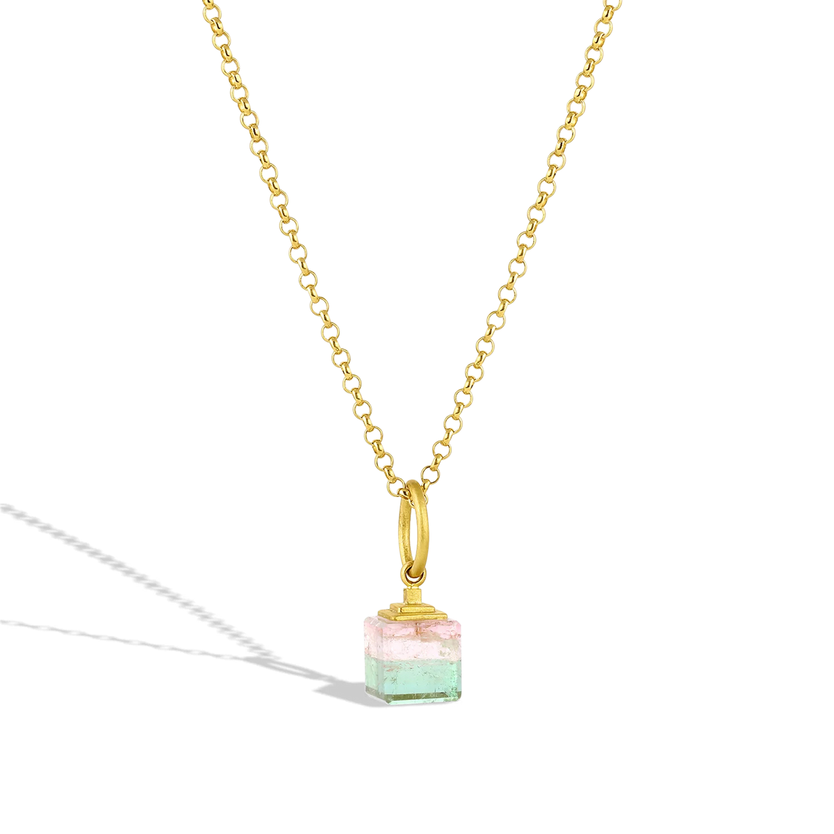 This modern-day ziggurat  (or step pyramid) features a custom cut bi-color mint green and palest pastel pink tourmaline cube topped with a golden step pyramid. The buttery gold pyramid seems to float above the colored cube, blending the ancient and new. Length approximately 23mm, W 8.5mm (L .9in W .3in).

Made with recycled 22k yellow gold and Brazilian tourmaline (8.8ctw). The chain is available separately.
