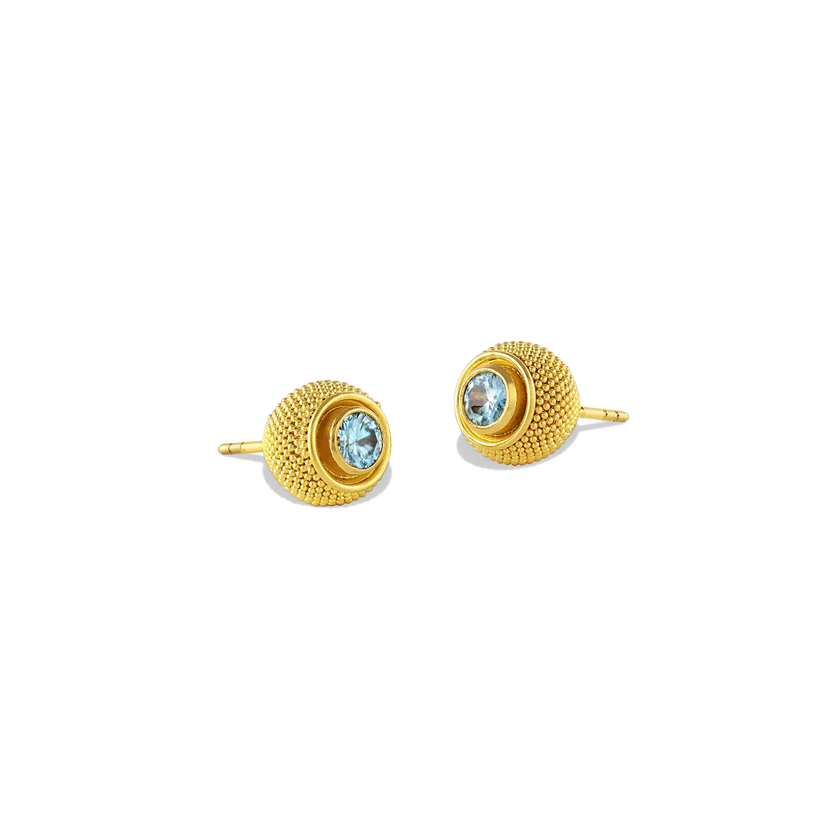 Elegant yet versatile, these cushion style stud earrings feature delicate all over granulation with a pop of color, courtesy of vivid blue zircons. Although ancient in technique, the granulation gives quite the modern look. The warm buttery tone of the gold and granulated texture gives the appearance of the pile on a velvet cushion and feels soft to the touch.

Other gemstone options are available, contact us at concierge@atelierwolff.com to discuss.