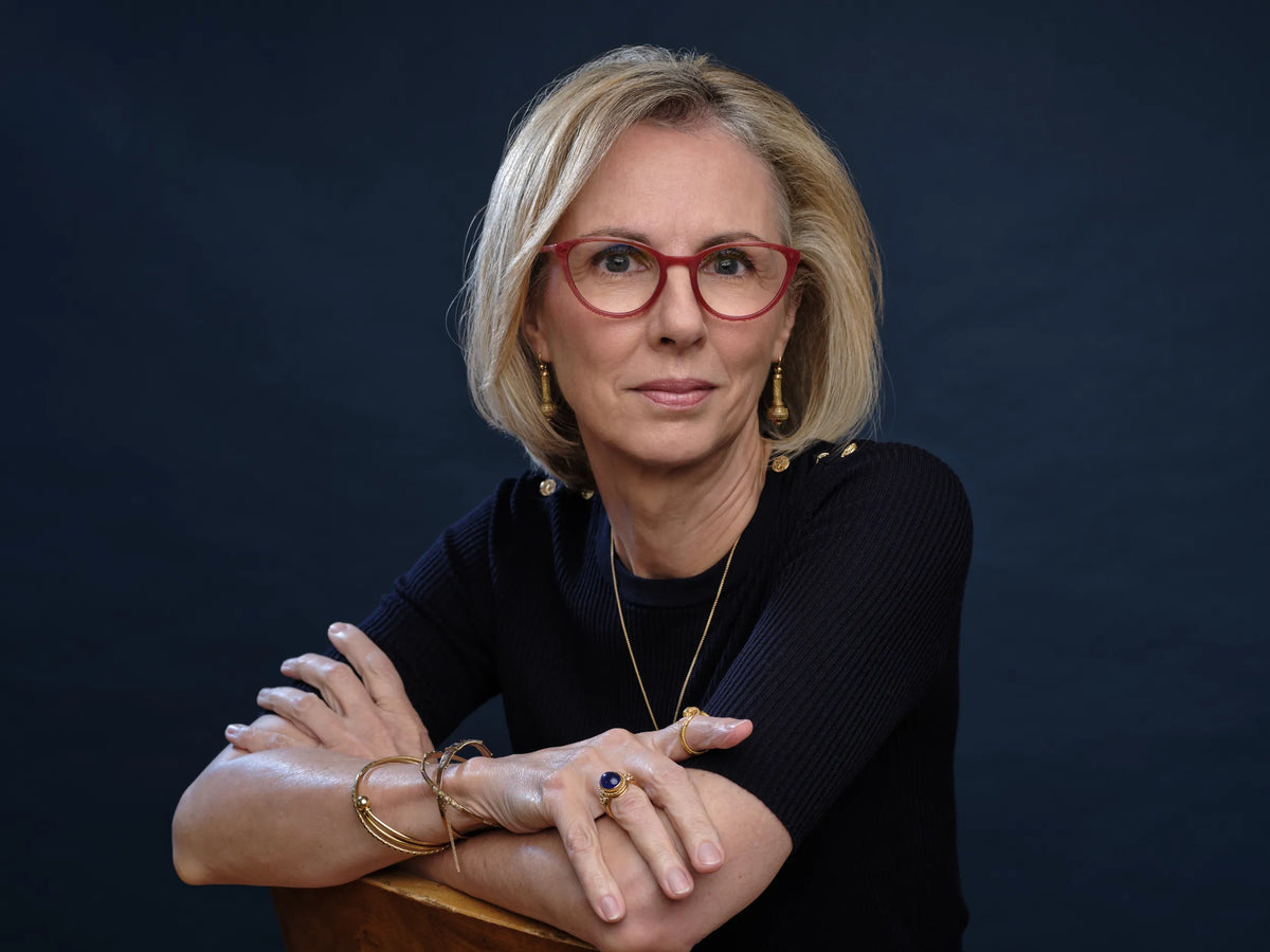 Portrait of Sharona Wolff, founder of Atelier Wolff, wearing gold rings, bracelets, and earrings from her collection